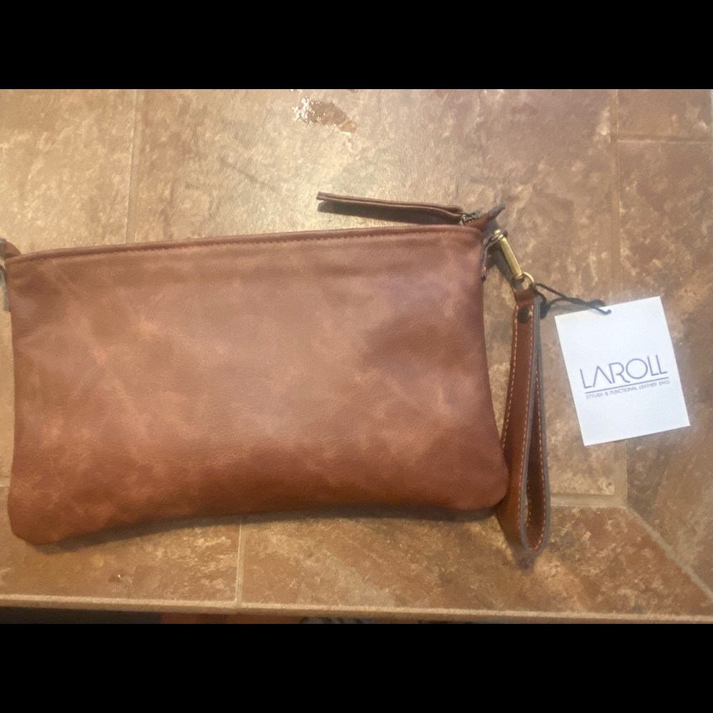 Real leather clutch bag with over the shoulder strap. Brand new with tags